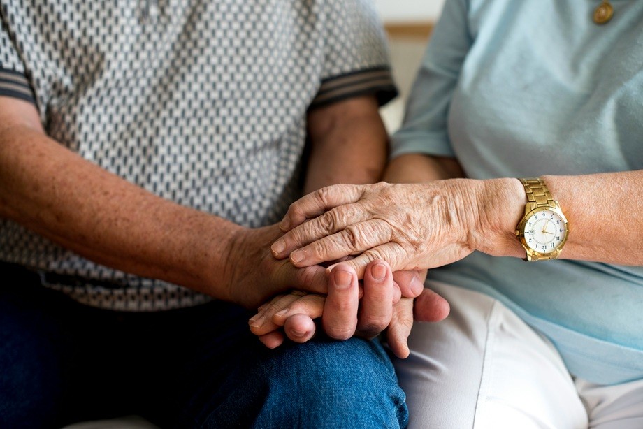 Older couple holding hands