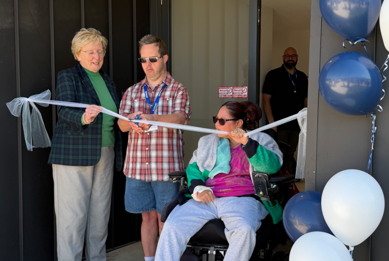 Man cutting ribbon
