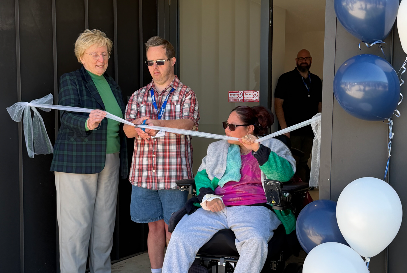 Man cutting ribbon